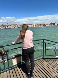 Woman standing looking out at the water